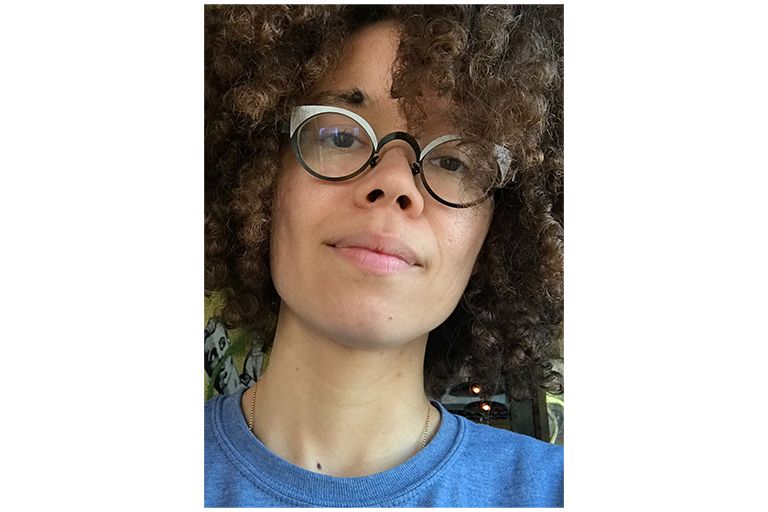 Headshot of Professor Owen. Curly hair, blue shirt, and glasses.
